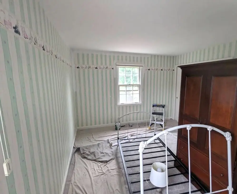 Before Bedroom with striped wallpaper and trim