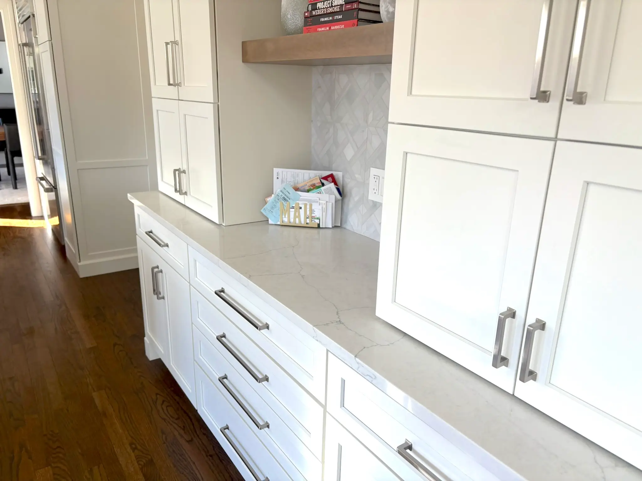 White kitchen cabinets and tile backsplash
